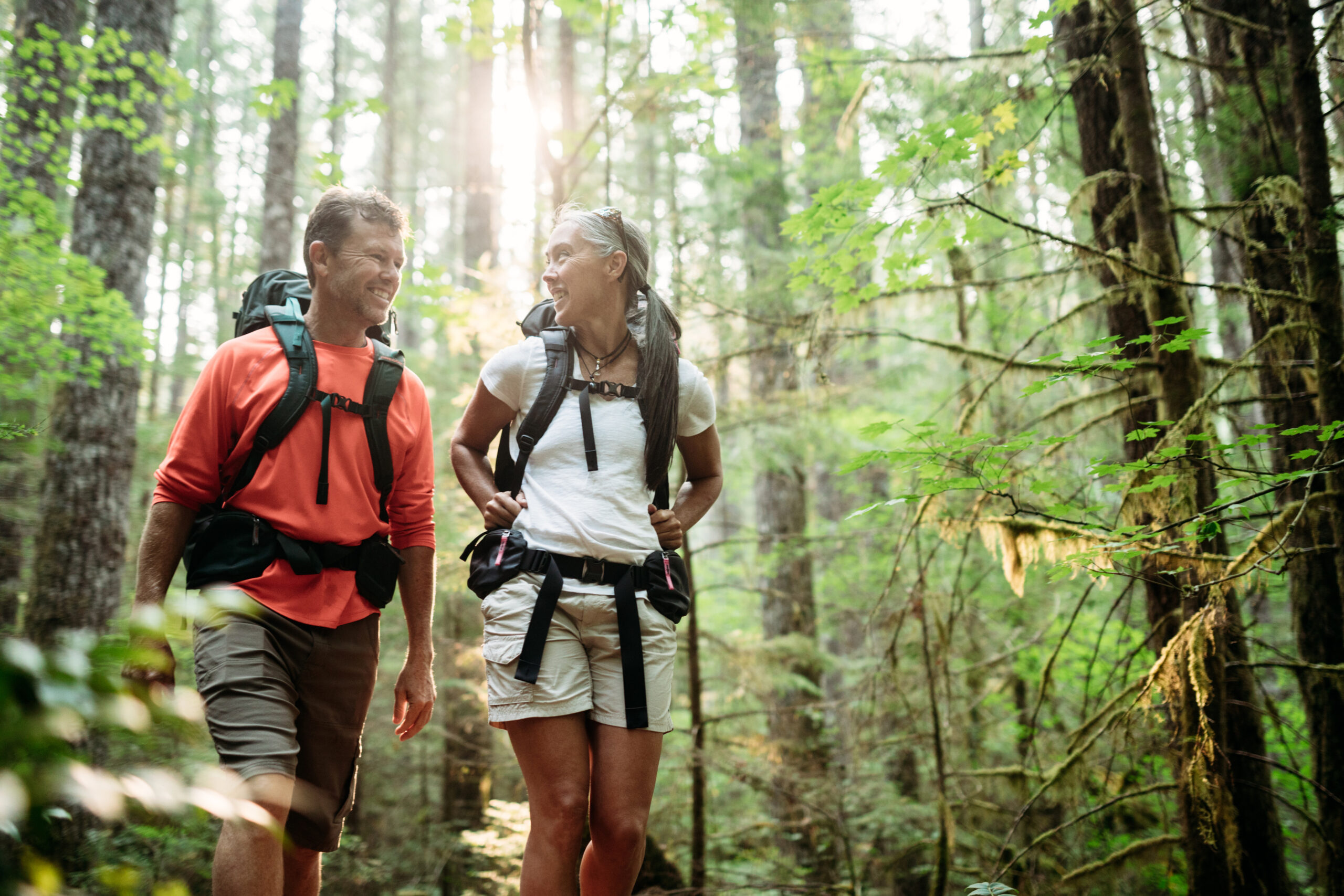 Mature Couple Backpacking in Forest